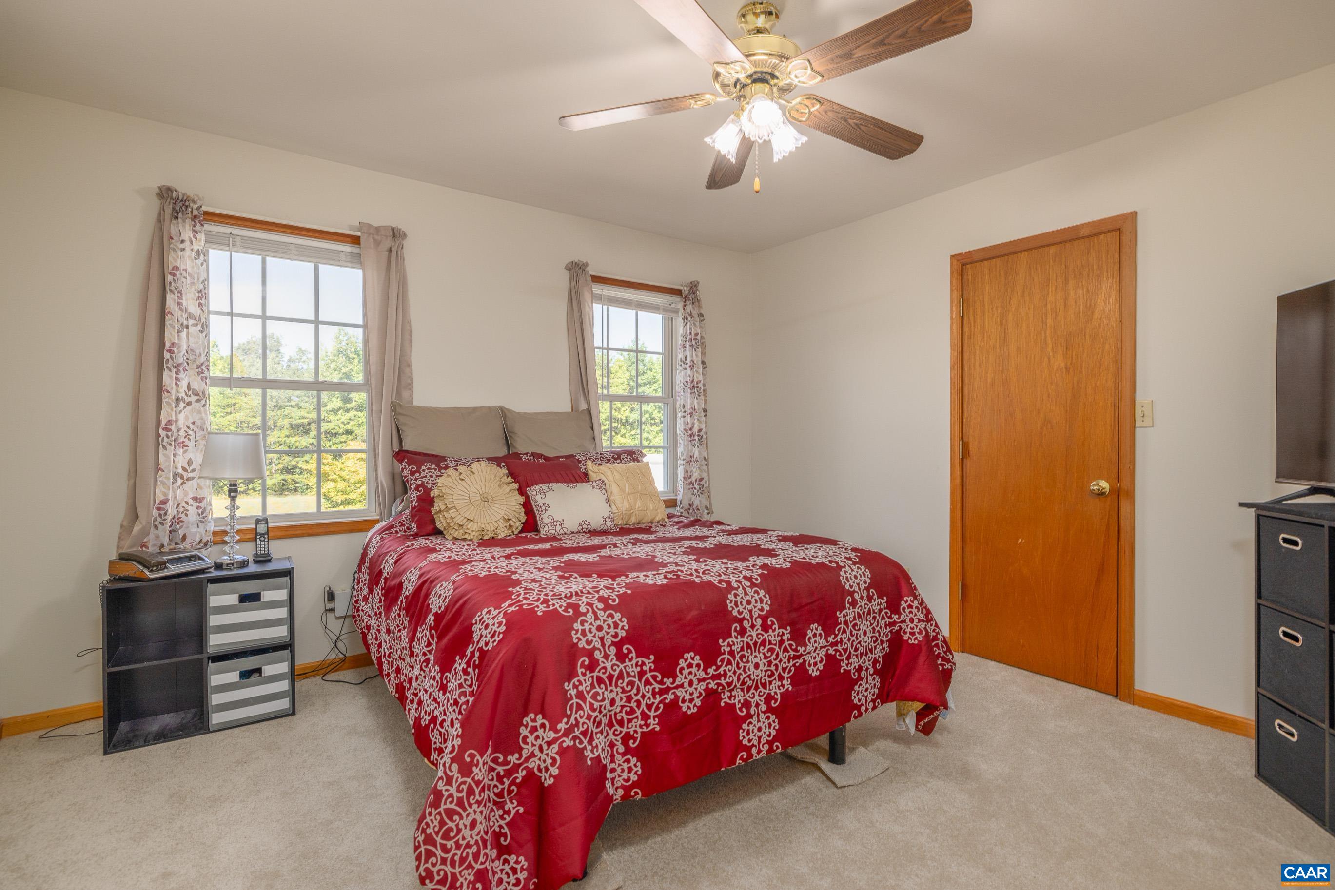 7839 Venable Road Kents Store, VA 23084 - Photo 23 of 51 a bedroom with a bed and a chandelier