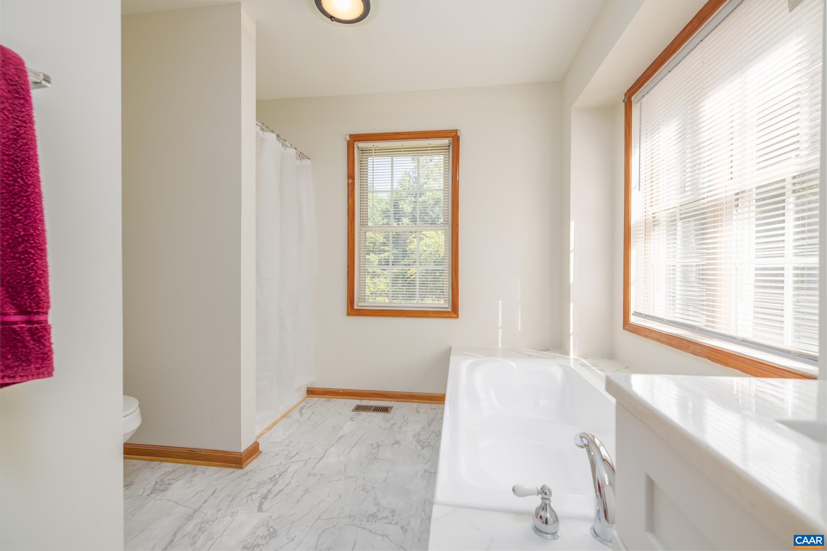 7839 Venable Road Kents Store, VA 23084 - Photo 25 of 51 a bathroom with a bathtub and next to a window