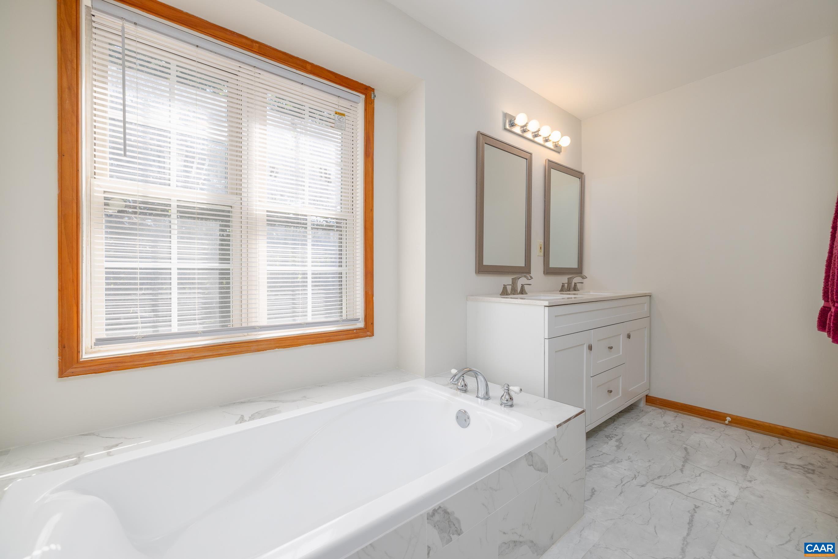 7839 Venable Road Kents Store, VA 23084 - Photo 26 of 51 a bathroom with a tub sink and mirror
