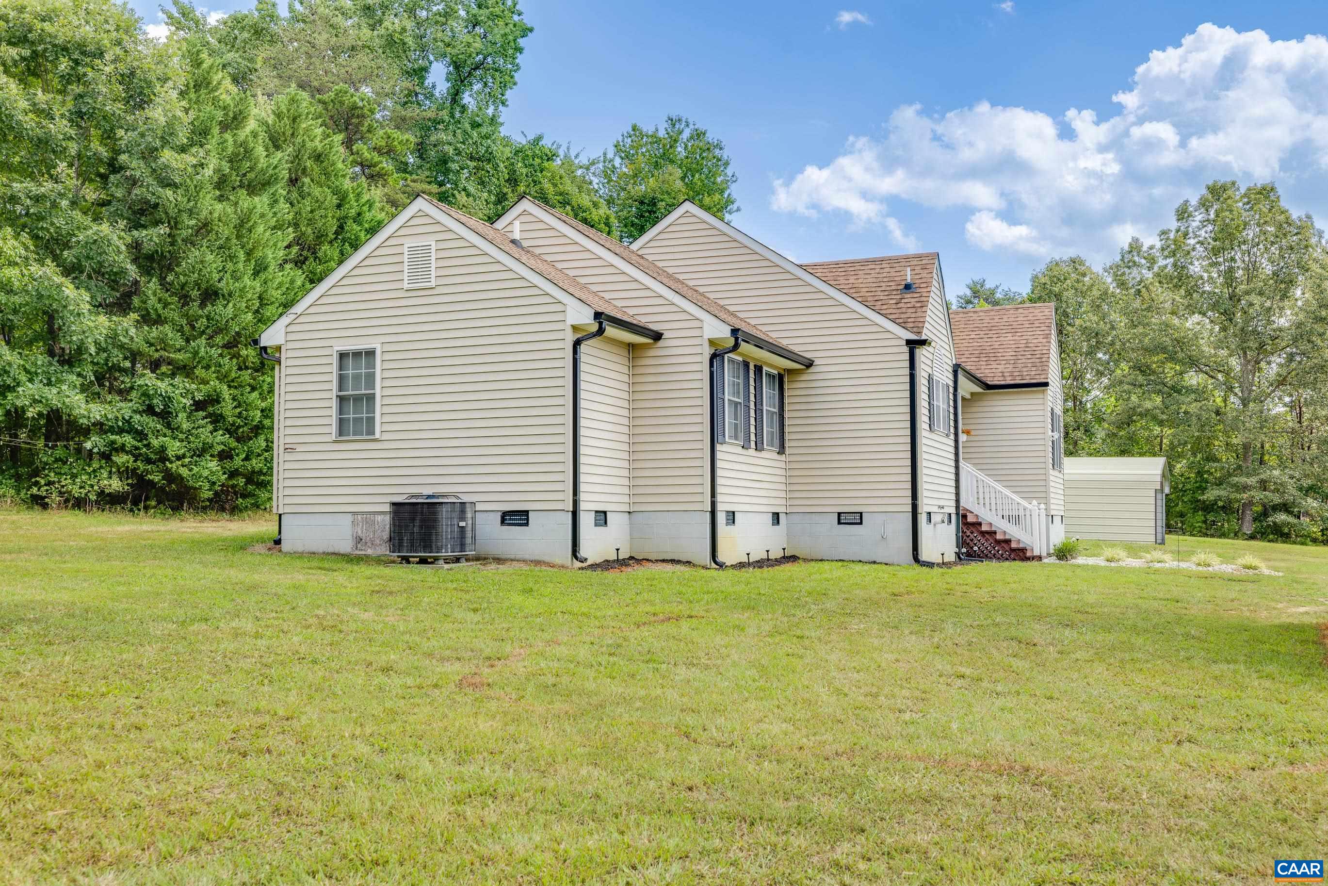 7839 Venable Road Kents Store, VA 23084 - Photo 5 of 51 a view of a house with a yard and garage