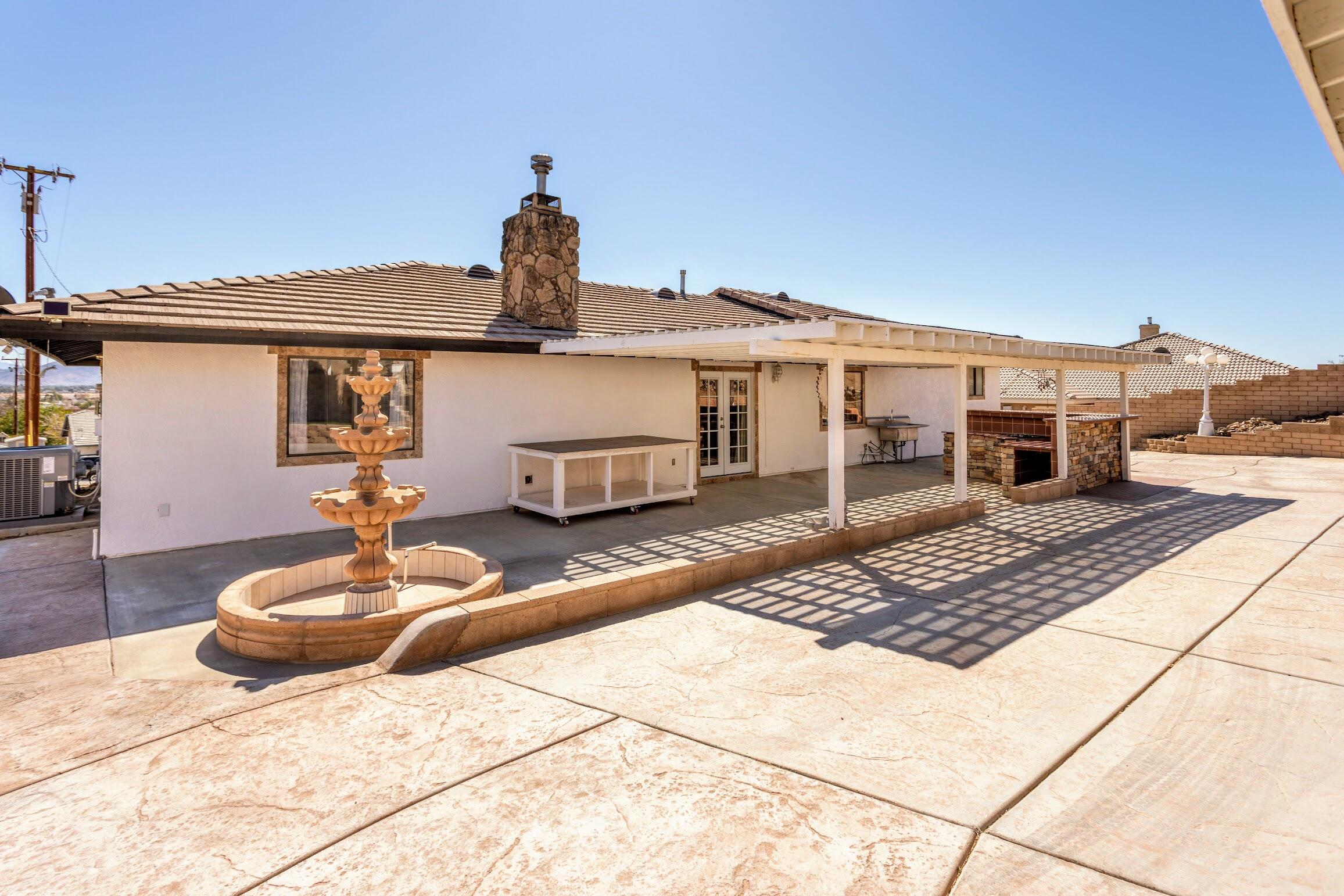 16276 Rancherias Road Apple Valley, CA 92307 - Photo 27 of 27 a front view of a house with a yard