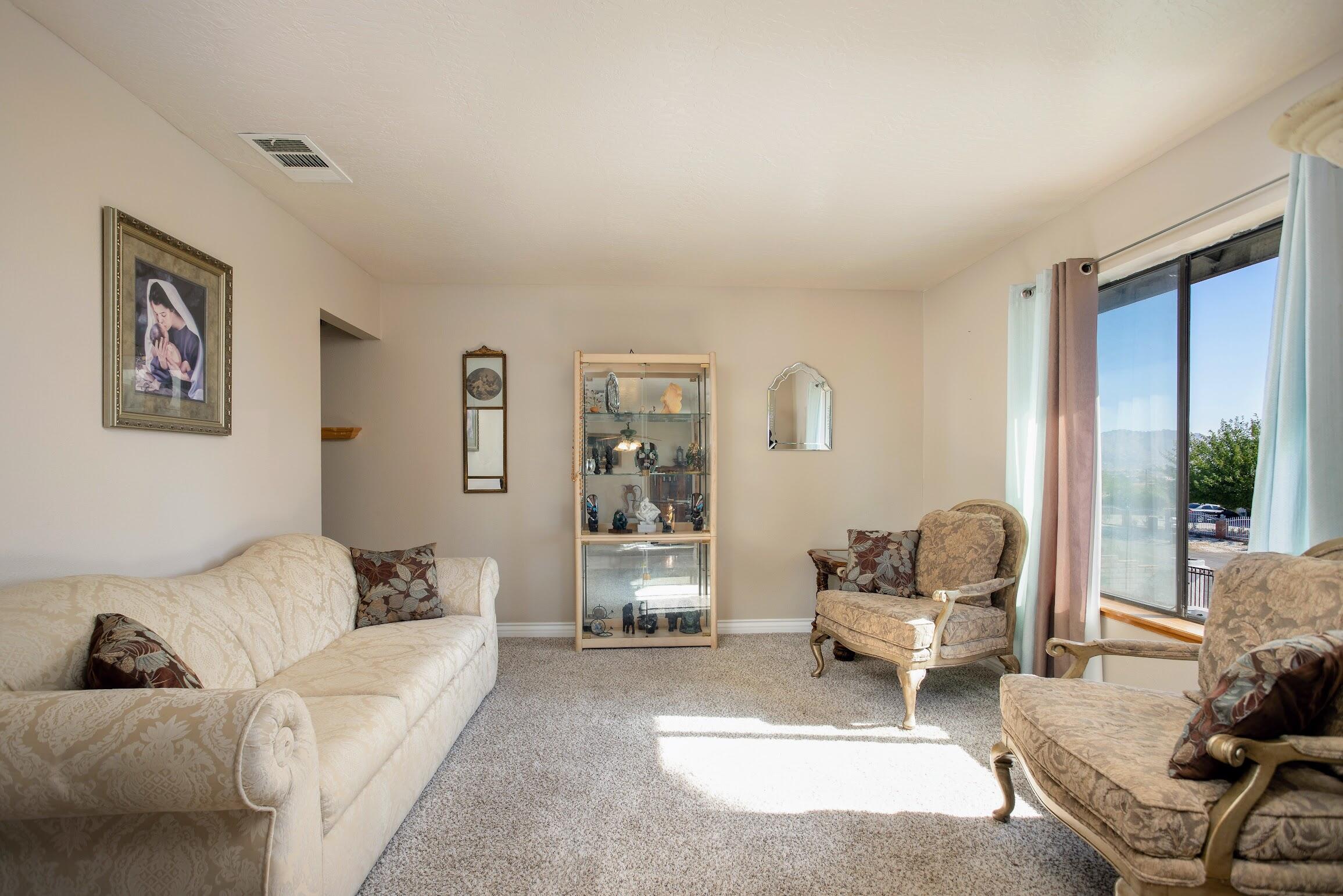16276 Rancherias Road Apple Valley, CA 92307 - Photo 7 of 27 a living room with furniture and a large window