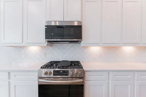 a kitchen with a stove and a microwave