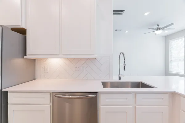 a kitchen with kitchen island a sink stove and refrigerator