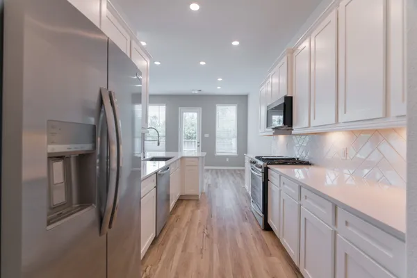 a stove top oven sitting inside of a kitchen