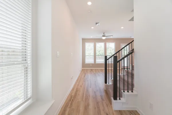 a view of entryway and hall with wooden floor