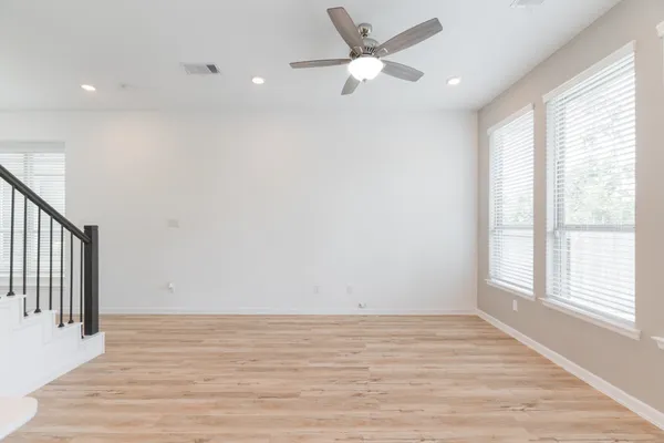 a view of kitchen with wooden floor and electronic appliances