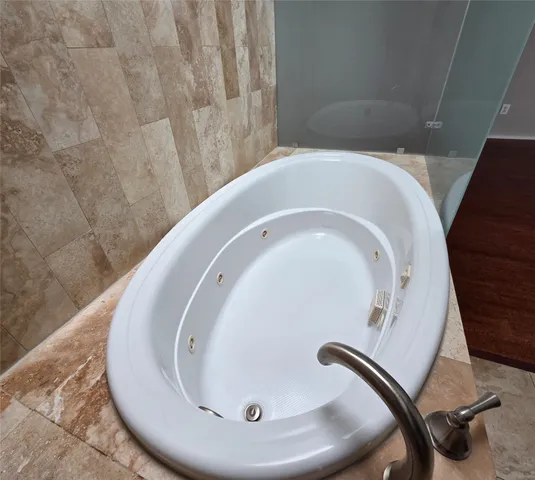 a bathroom with a sink toilet a mirror and shower