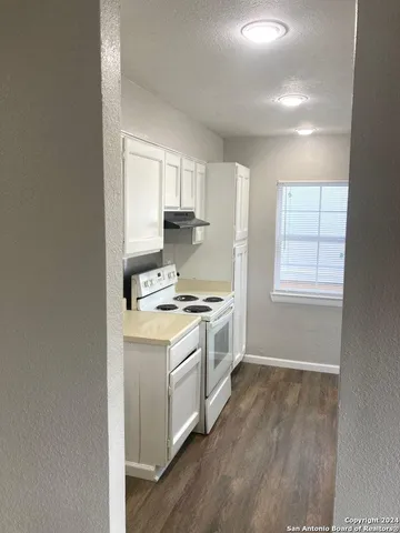 a kitchen with a stove a sink and a microwave