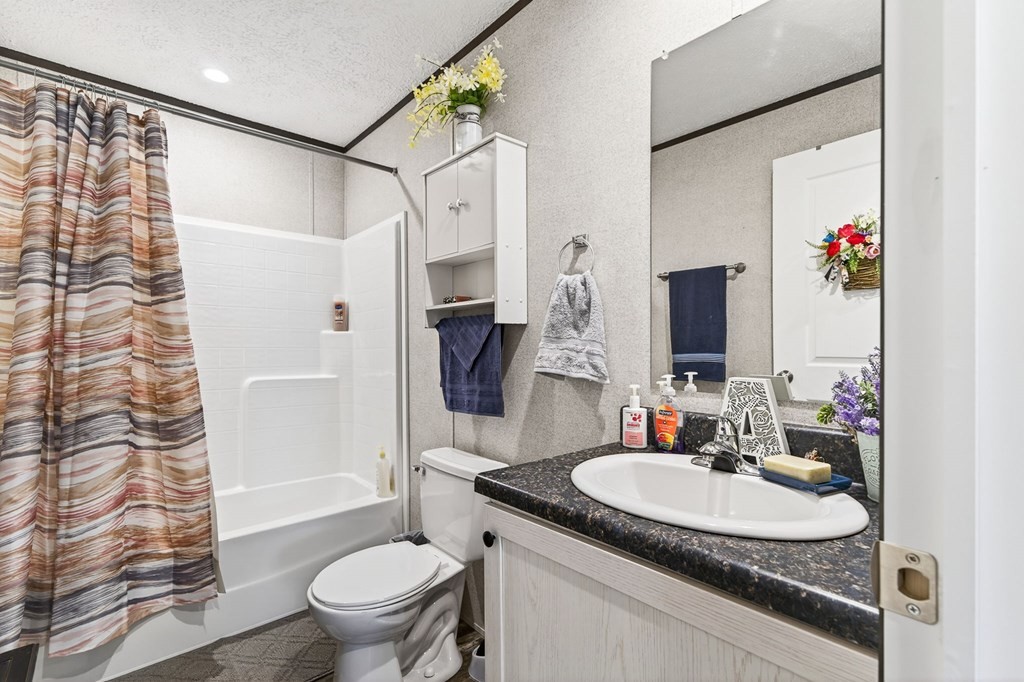 156 Falls View Road Sparta, TN 38583 - Photo 14 of 29 a bathroom with a granite countertop sink and a mirror