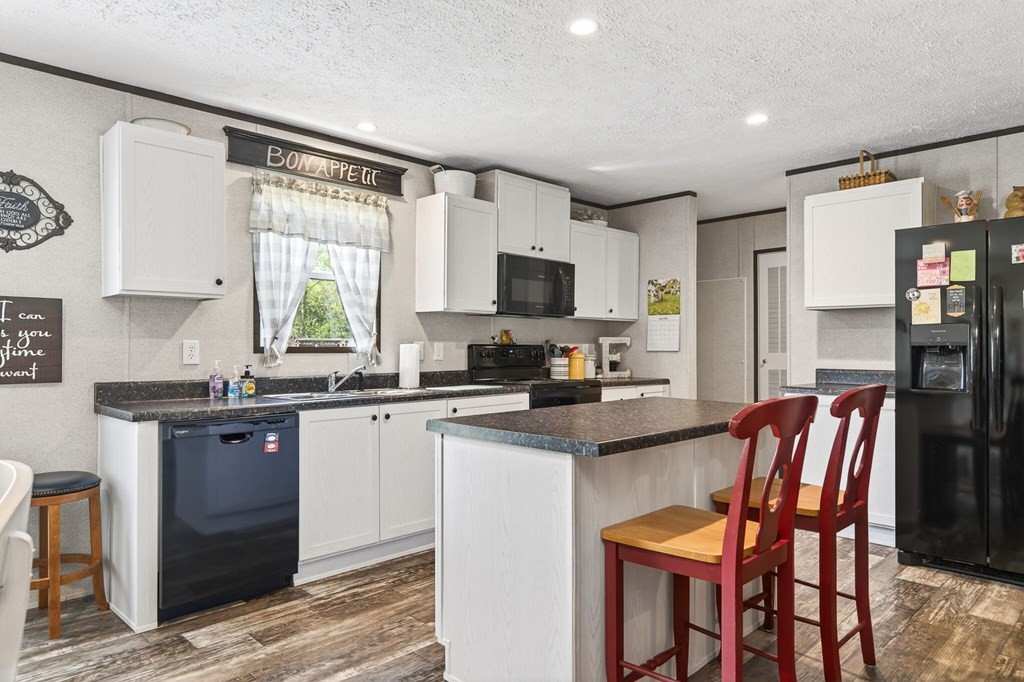 156 Falls View Road Sparta, TN 38583 - Photo 3 of 29 a kitchen with stainless steel appliances granite countertop a stove a sink dishwasher a refrigerator with a dining table and chairs