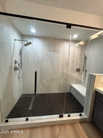 a bathroom with a shower and a mirror