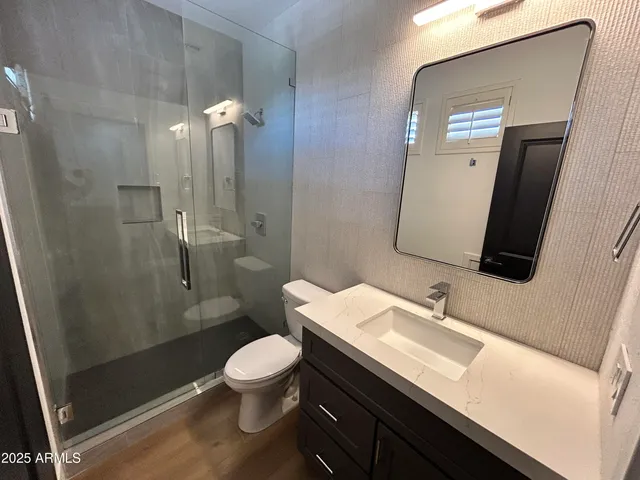 a white toilet sitting next to a white sink