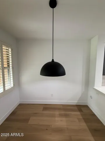 a view of a room with a ceiling fan and a window