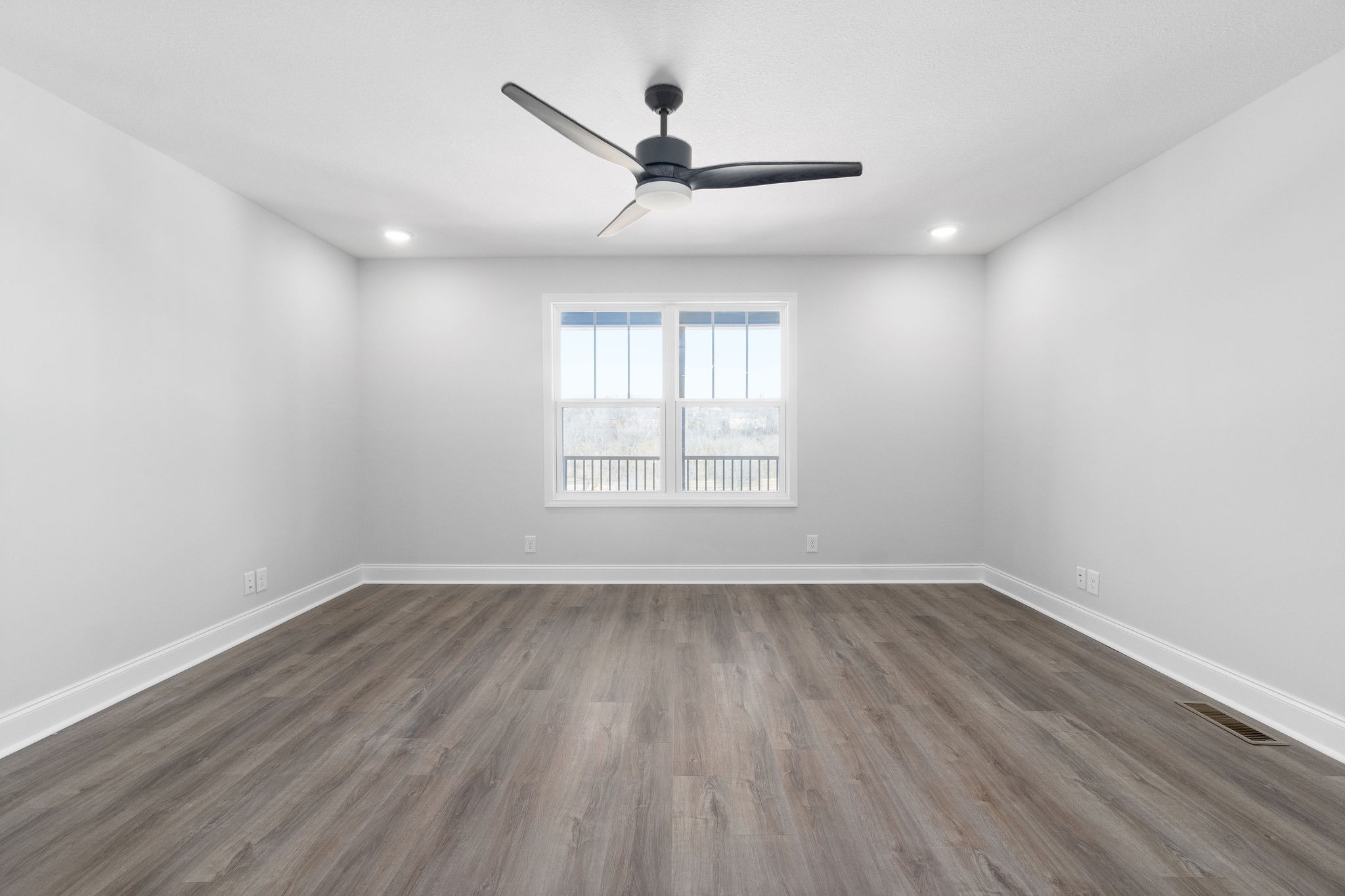 64 West High Street Clarksville, TN 37040 - Photo 4 of 22 an empty room with wooden floor ceiling fan and windows