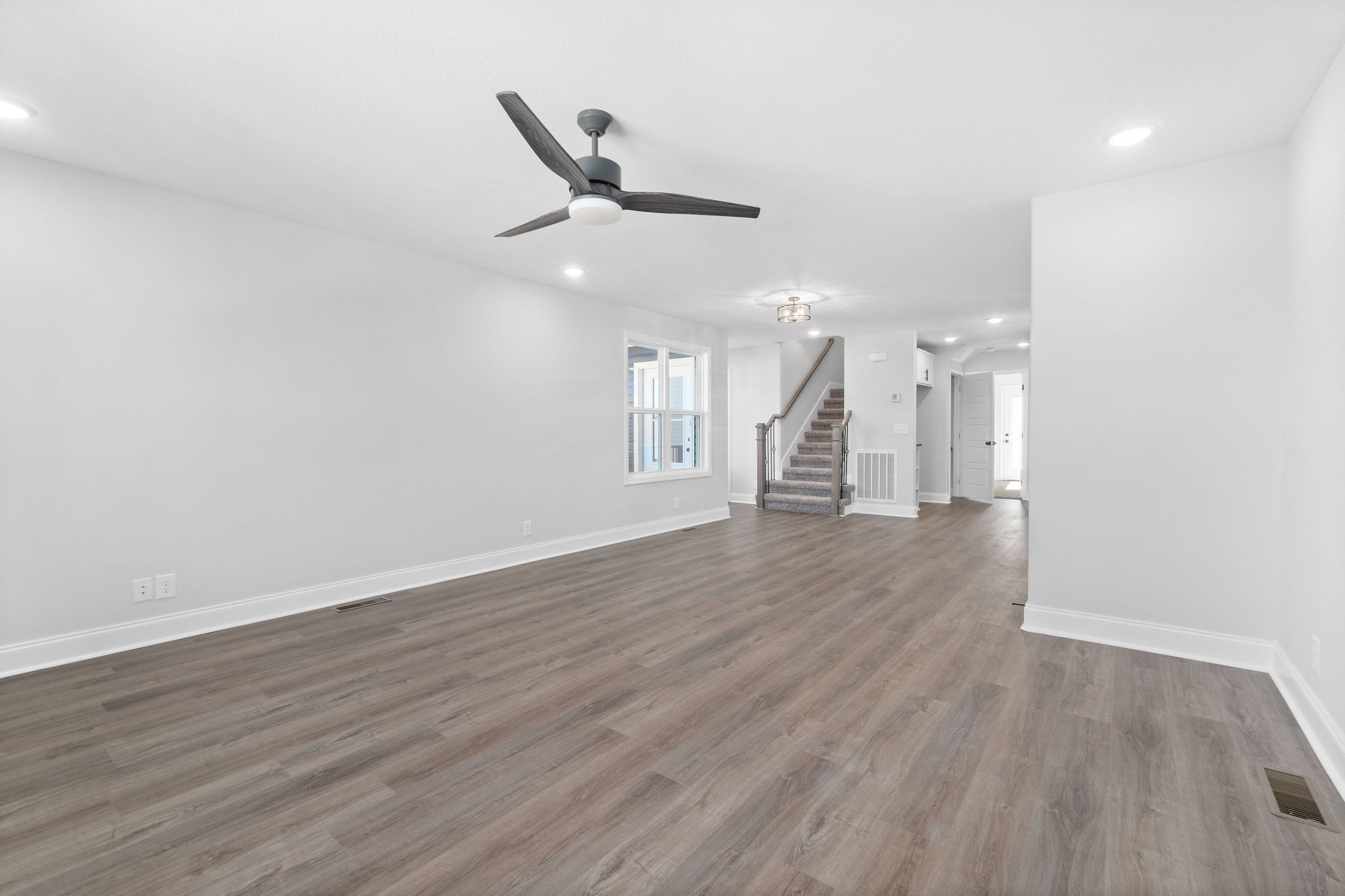 64 West High Street Clarksville, TN 37040 - Photo 5 of 22 an empty room with wooden floor and windows