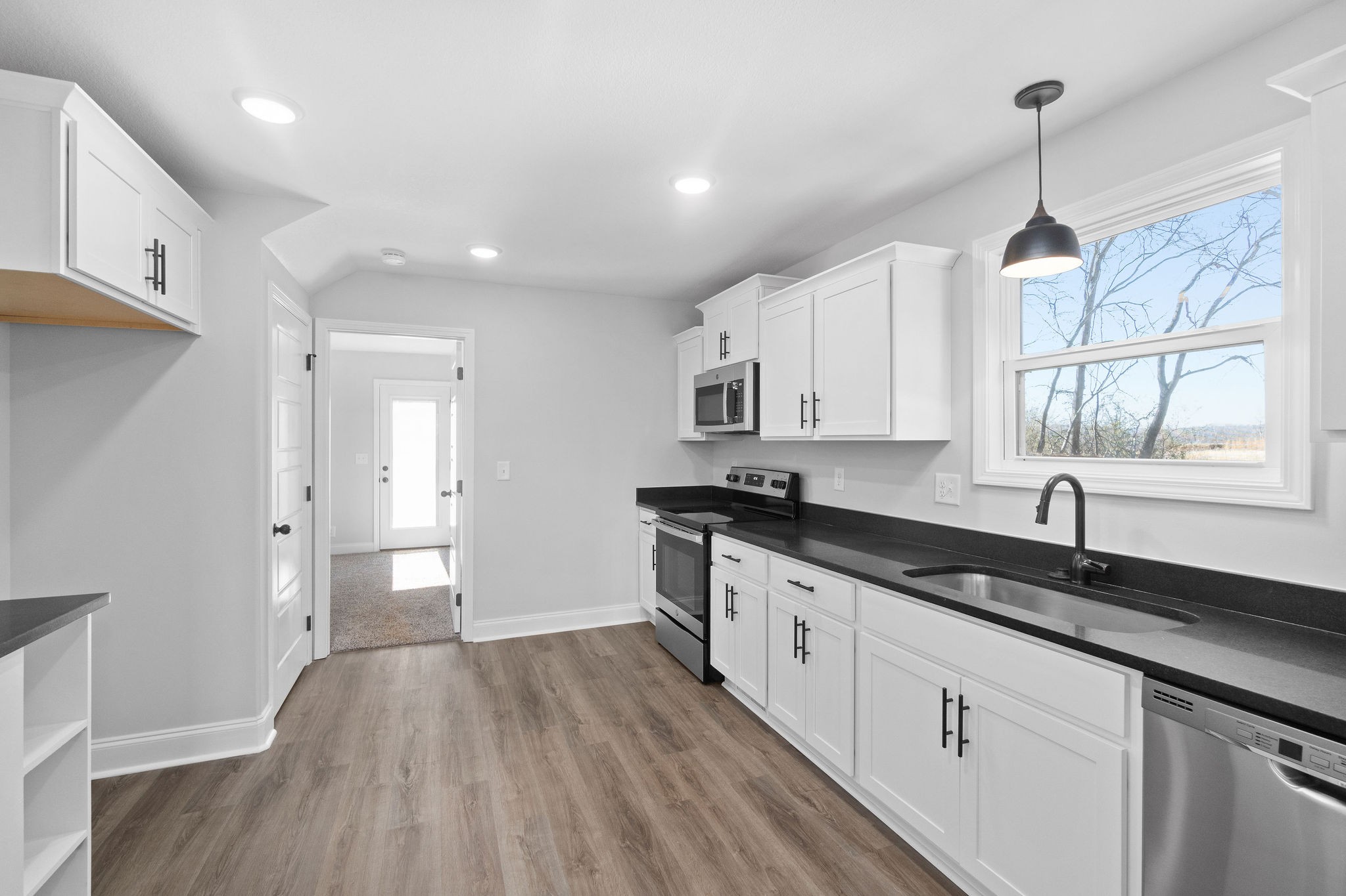 64 West High Street Clarksville, TN 37040 - Photo 9 of 22 a kitchen with granite countertop a sink stove and cabinets