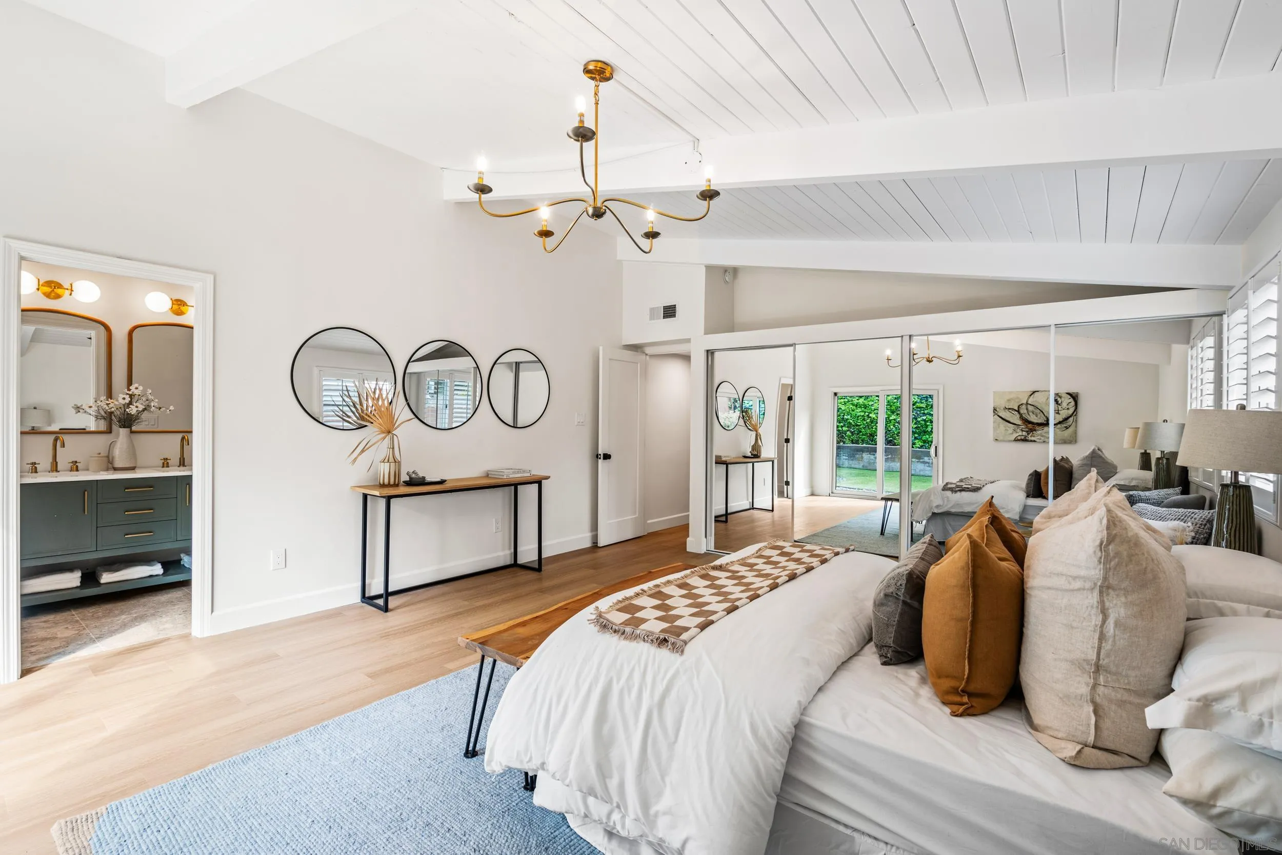 3448 Larga Circle San Diego, CA 92110 - Photo 17 of 36 a bedroom with a bed a mirror and a window