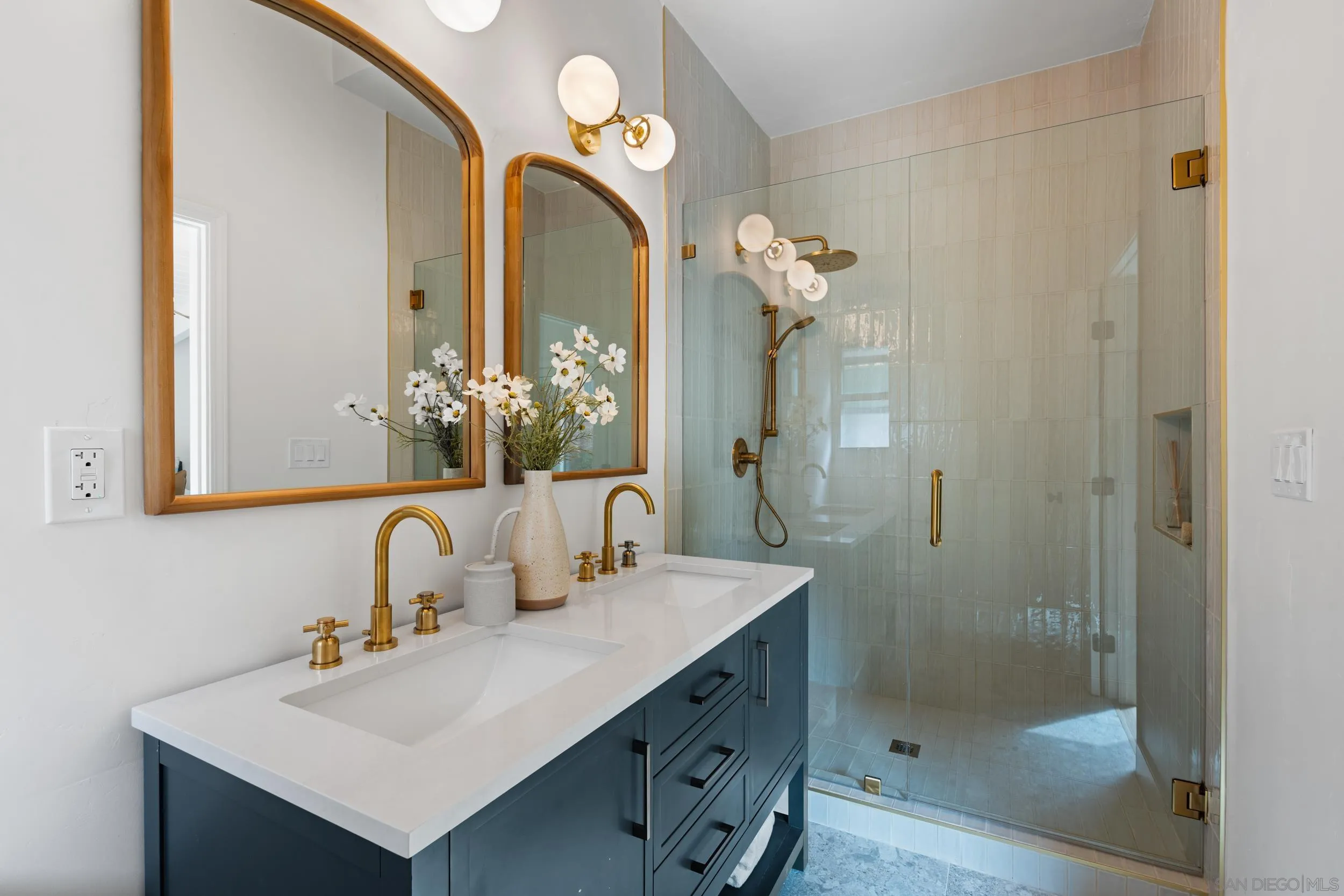 3448 Larga Circle San Diego, CA 92110 - Photo 19 of 36 a bathroom with a sink a mirror a vanity and a shower