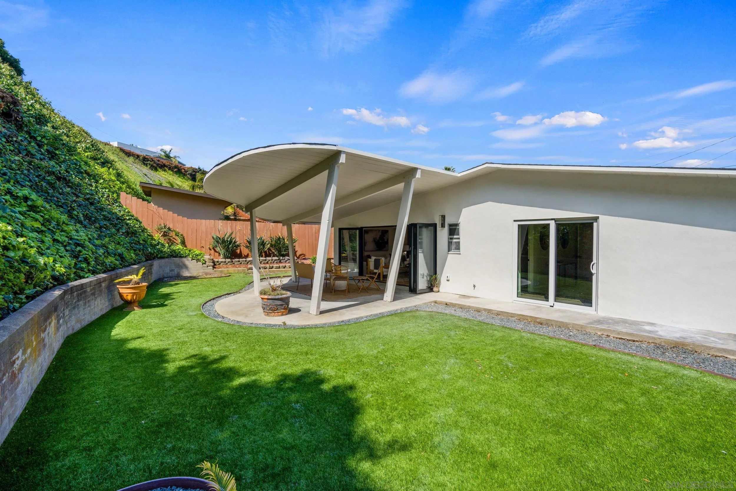 3448 Larga Circle San Diego, CA 92110 - Photo 2 of 36 a view of a house with a backyard porch and sitting area