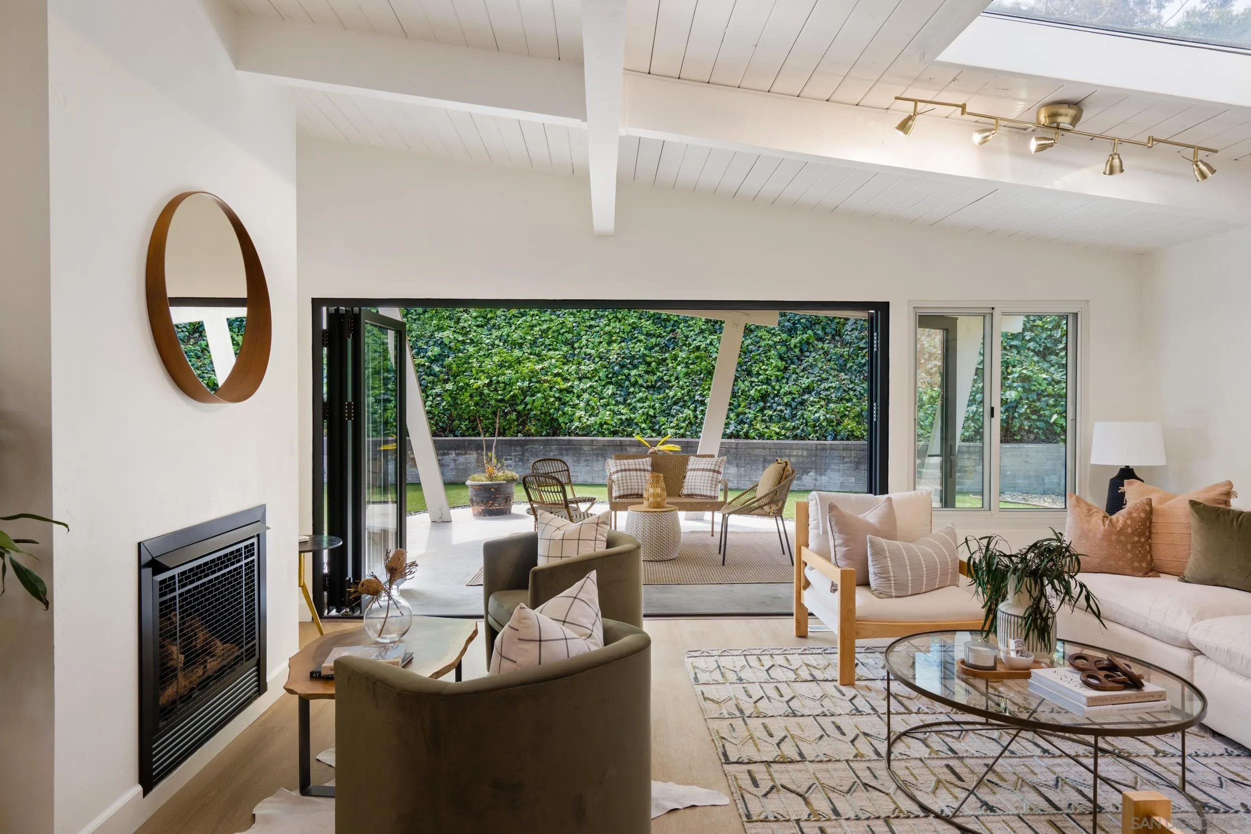 3448 Larga Circle San Diego, CA 92110 - Photo 4 of 36 a living room with fireplace furniture and a floor to ceiling window