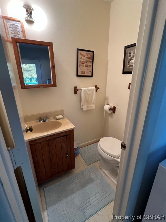 790 Long Point Lane Topping, VA 23169 - Photo 17 of 26 Bathroom featuring tile floors, toilet, and oversized vanity