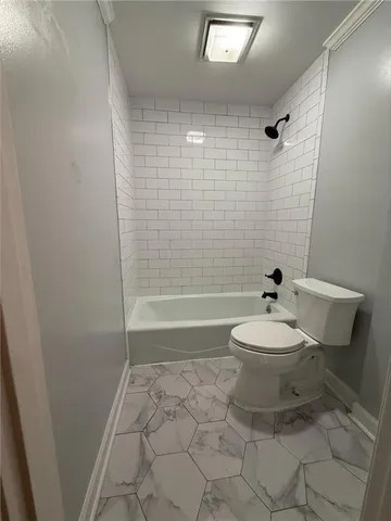 a bathroom with a toilet a sink and shower