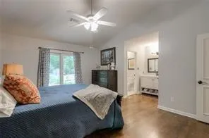 a spacious bedroom with a large bed and a chandelier