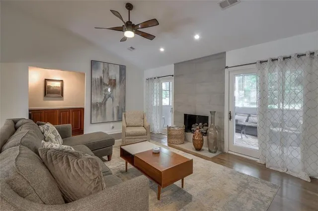 a living room with furniture and a fireplace