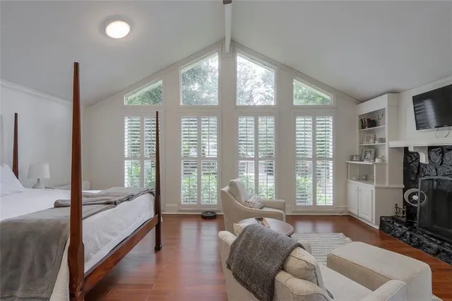a bedroom with furniture and a large window