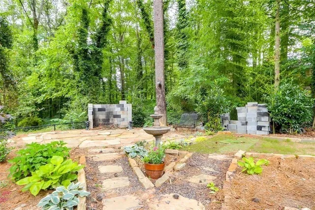 a backyard of a house with table and chairs