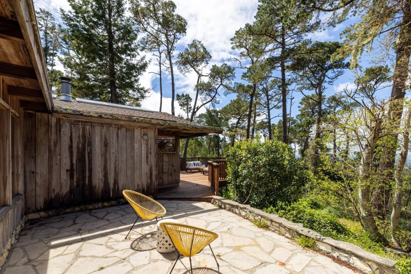 73 Mt Devon Road Carmel Highlands, CA 93923 - Photo 56 of 88 a backyard of a house with table and chairs