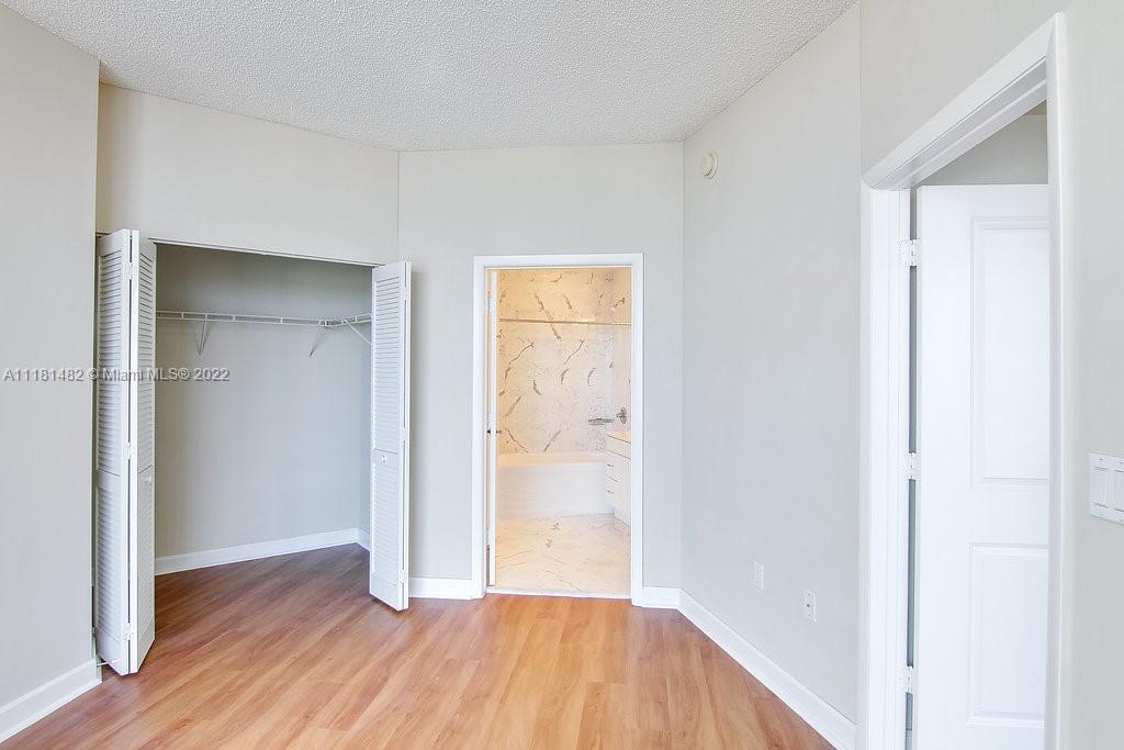 1500 Bay Road, Unit C2312 Miami Beach, FL 33139 - Photo 14 of 20 a view of a hallway with wooden floor
