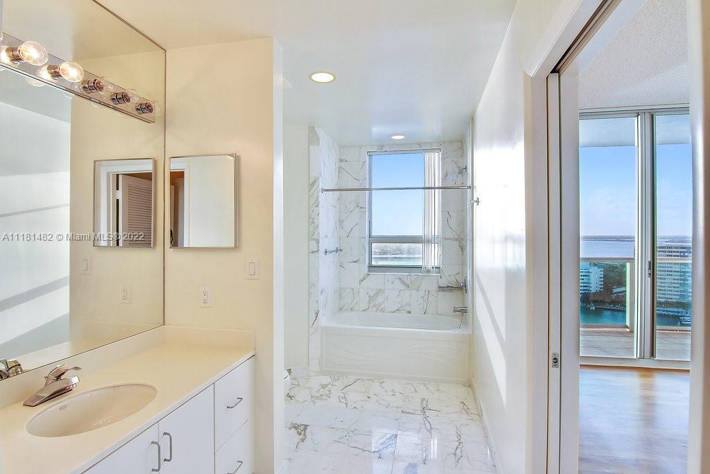 1500 Bay Road, Unit C2312 Miami Beach, FL 33139 - Photo 18 of 20 a bathroom with a sink shower and a mirror
