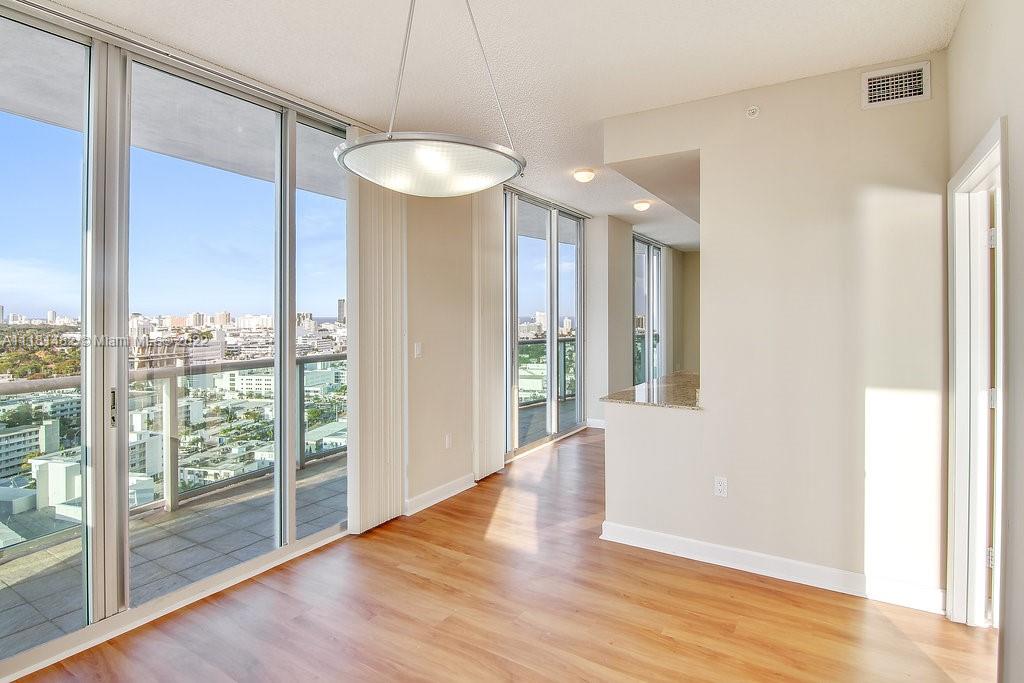 1500 Bay Road, Unit C2312 Miami Beach, FL 33139 - Photo 2 of 20 a view of an empty room with wooden floor and a window
