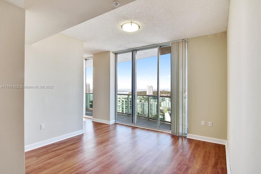 1500 Bay Road, Unit C2312 Miami Beach, FL 33139 - Photo 7 of 20 wooden floor in an empty room with a window