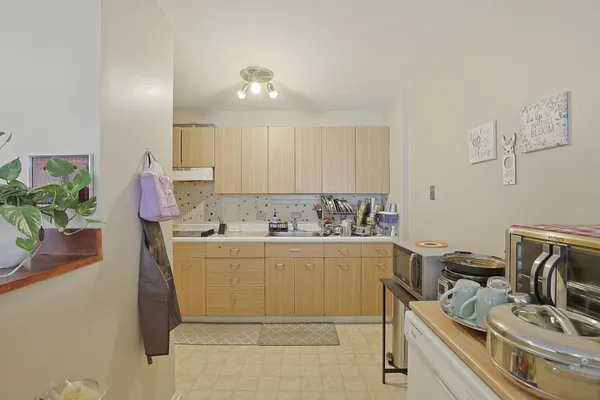 a room with a sink cabinets and wooden floor