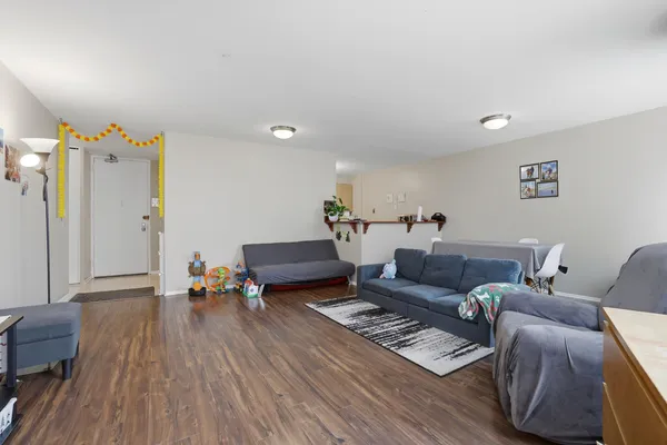 a living room with furniture and wooden floor
