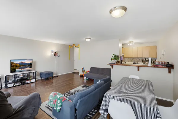 a living room with furniture kitchen view and a table