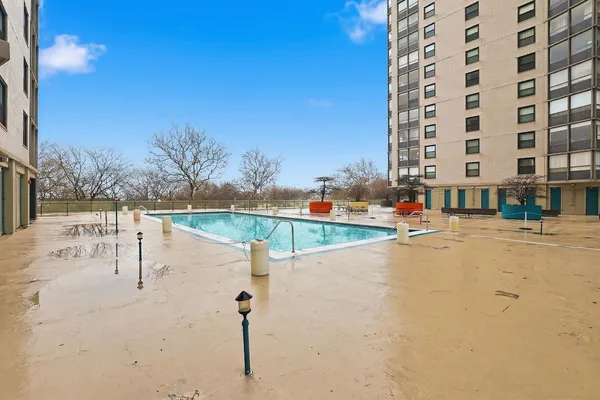 a view of swimming pool with a lounge chair