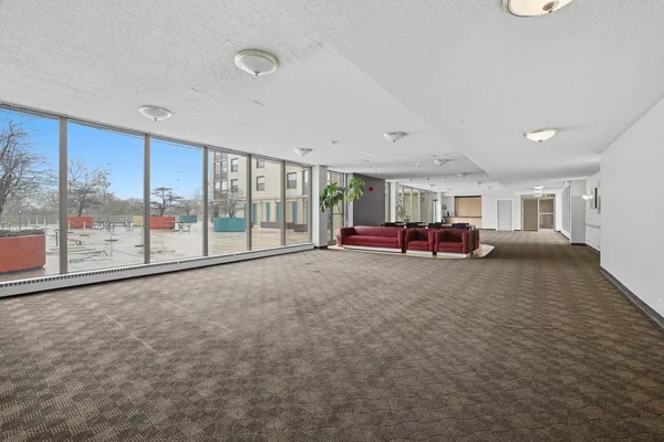 a living room with furniture and large window