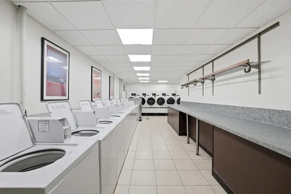 a large white kitchen with a large window