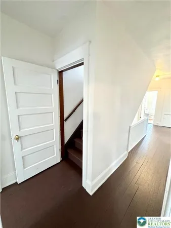 a view of a room with wooden floor