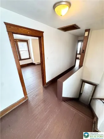 a view of a livingroom with wooden floor and chair