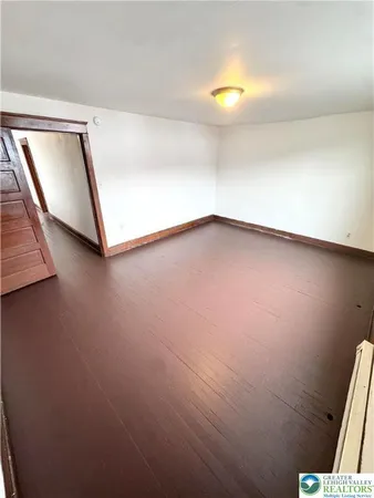 a view of an empty room and wooden floor
