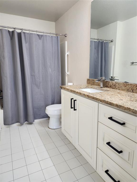 5455 Vineland Road, Unit 3105 Orlando, FL 32811 - Photo 7 of 11 a bathroom with a granite countertop sink and a mirror