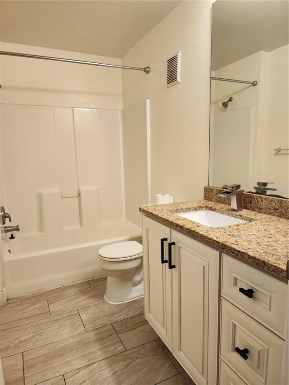 5455 Vineland Road, Unit 3105 Orlando, FL 32811 - Photo 8 of 11 a bathroom with a granite countertop sink a toilet and shower