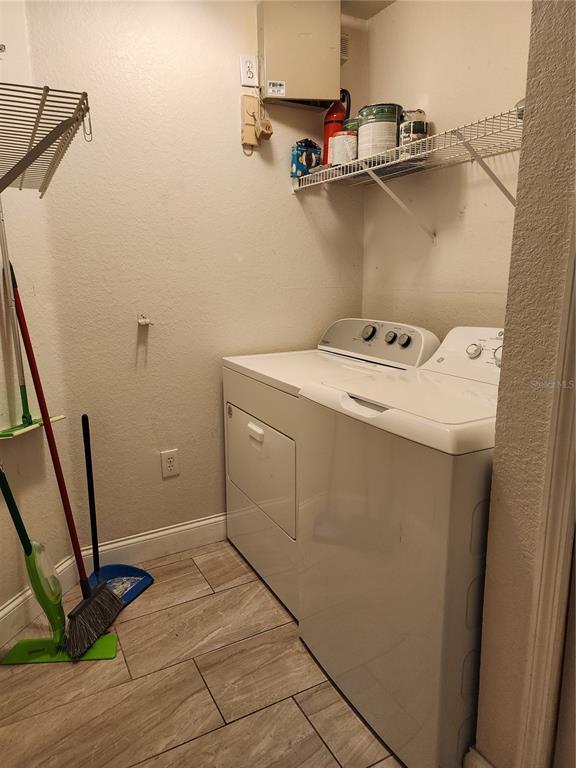 5455 Vineland Road, Unit 3105 Orlando, FL 32811 - Photo 9 of 11 a utility room with dryer and washer