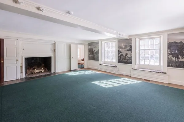 a view of empty room with fireplace and window