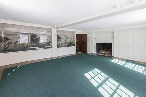 a view of empty room with a fireplace